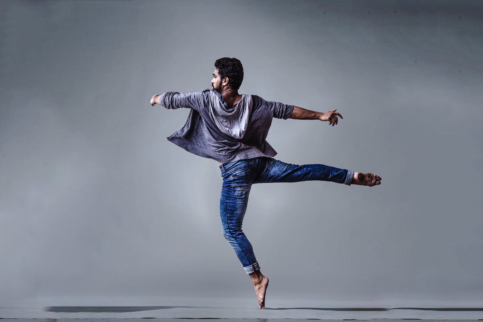 Man Wearing Blue Jeans Doing Pirouette Spin